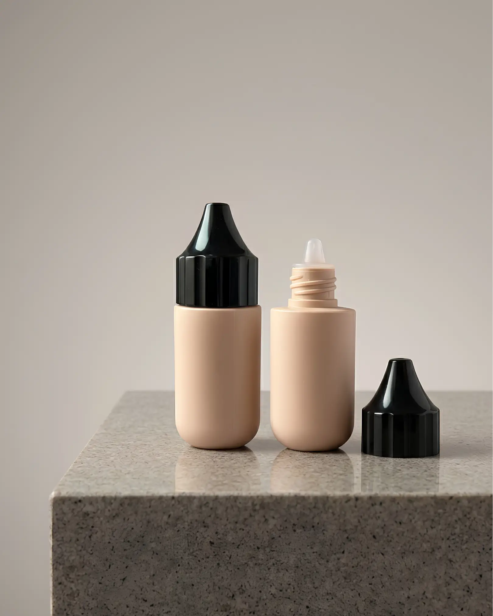 Minimalist matte terracotta cylindrical bottle placed on a concrete pedestal with diagonal shadows.