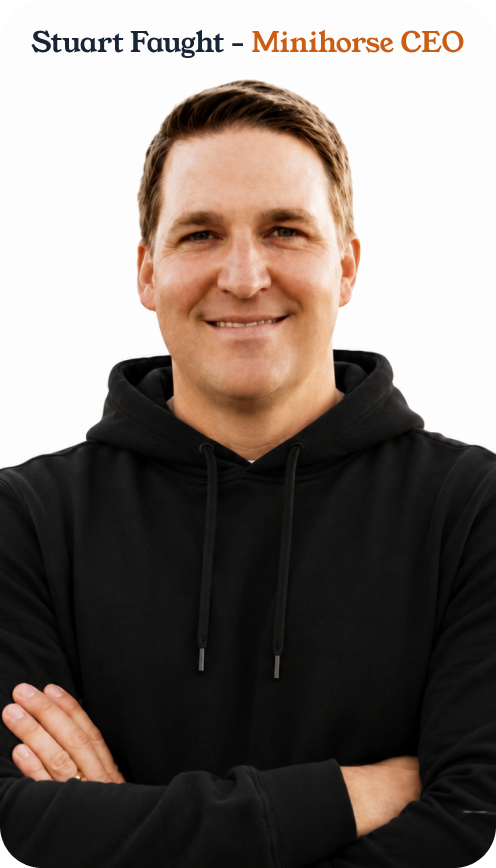 Smiling man with crossed arms wearing a black hoodie on a white background.