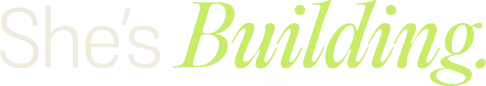 Text reading 'She's Building.' with 'Building.' in bright green cursive font.