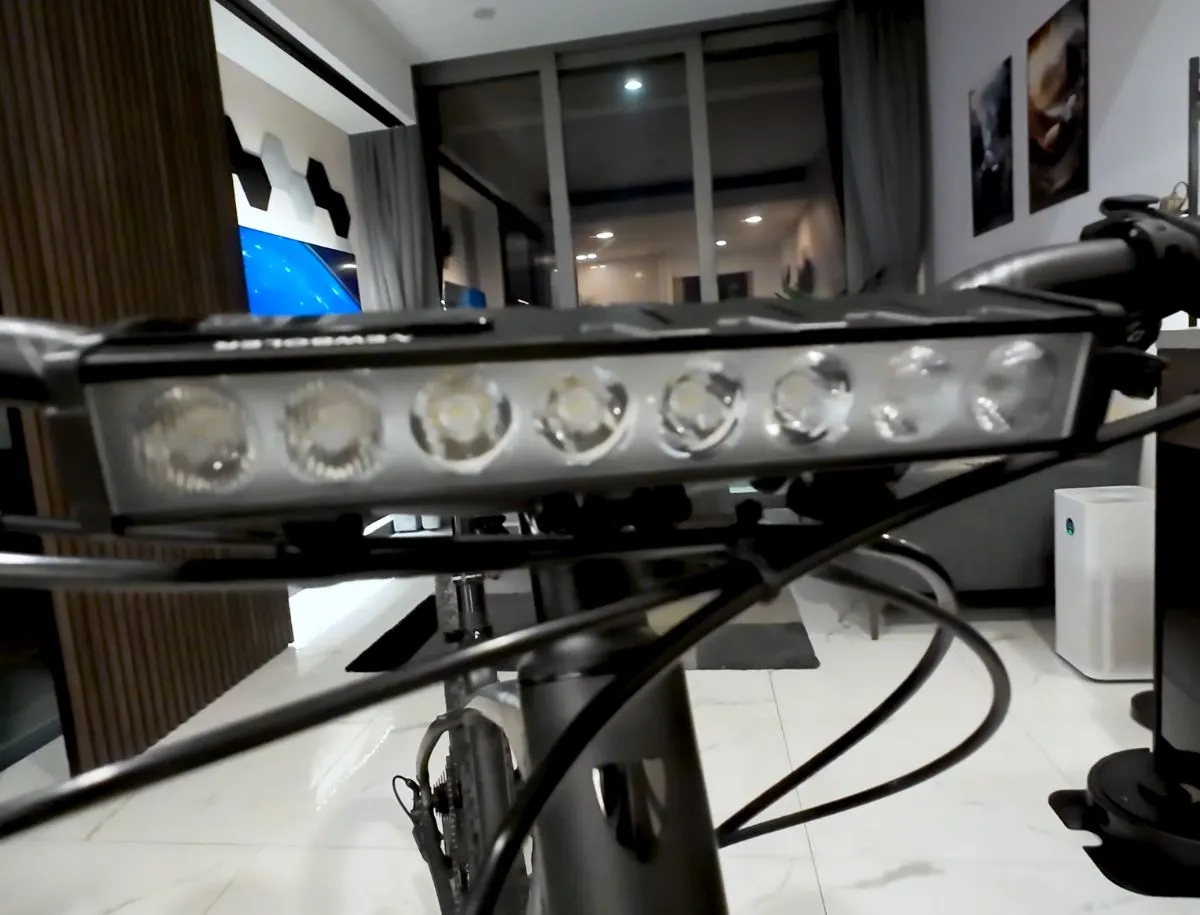 Newboler 10000 lumen bike light with 8 LED array mounted on drop bar handlebars, close up of light housing