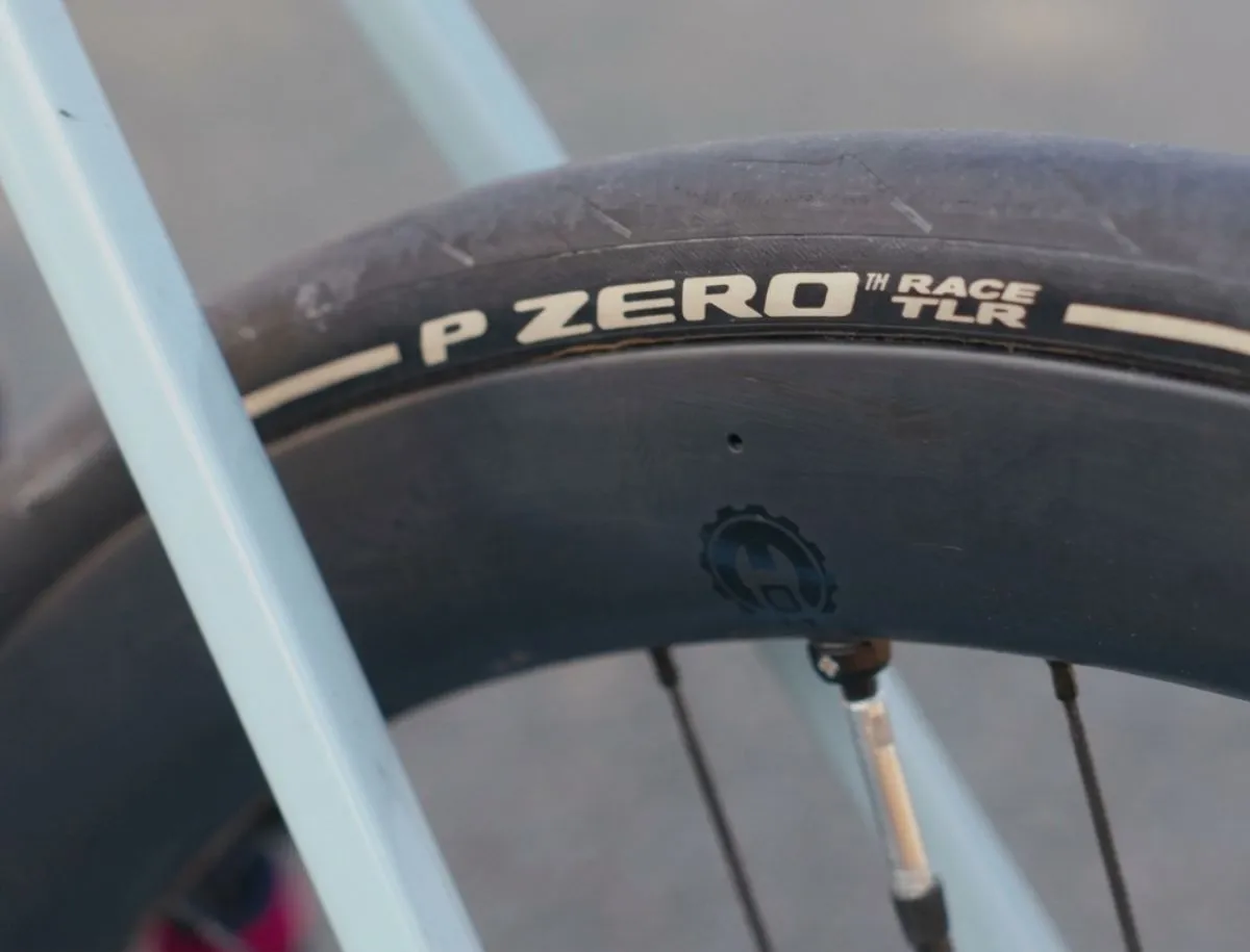 Pirelli P Zero Race TLR tubeless tyre mounted on Elitewheels carbon deep-section rim on Trek Domane SL5, showing tyre sidewall branding and disc brake rotor
