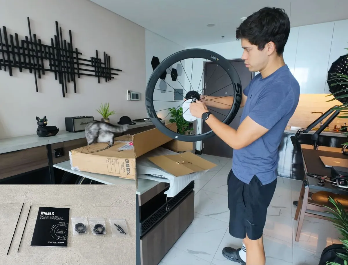 Mike Dee unboxing the Superteam Classic Pro carbon wheelset at home, with wheel manual, spare spokes, and valve stems laid out