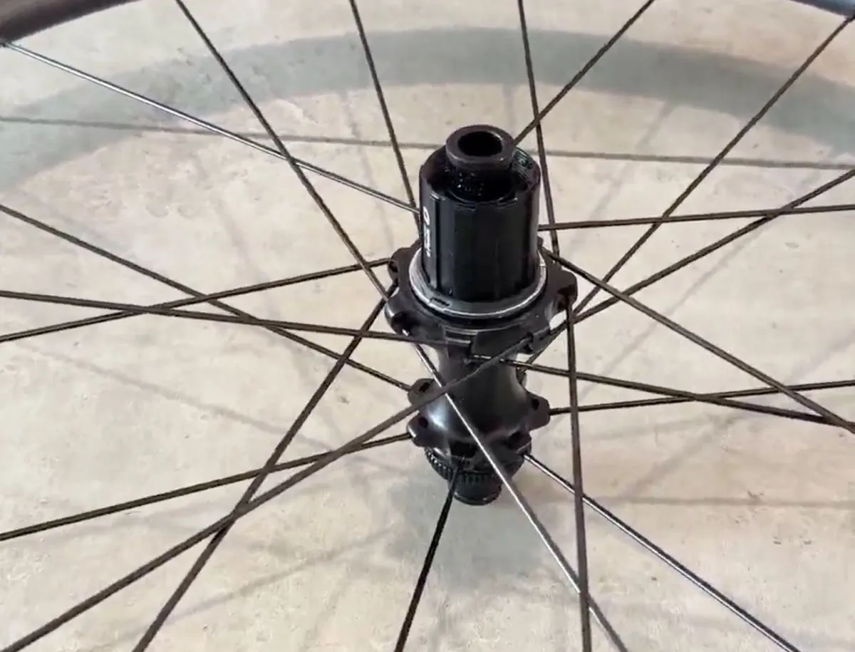 Close-up of the Superteam CX40 six-pawl hub on the Classic Pro carbon wheelset front wheel