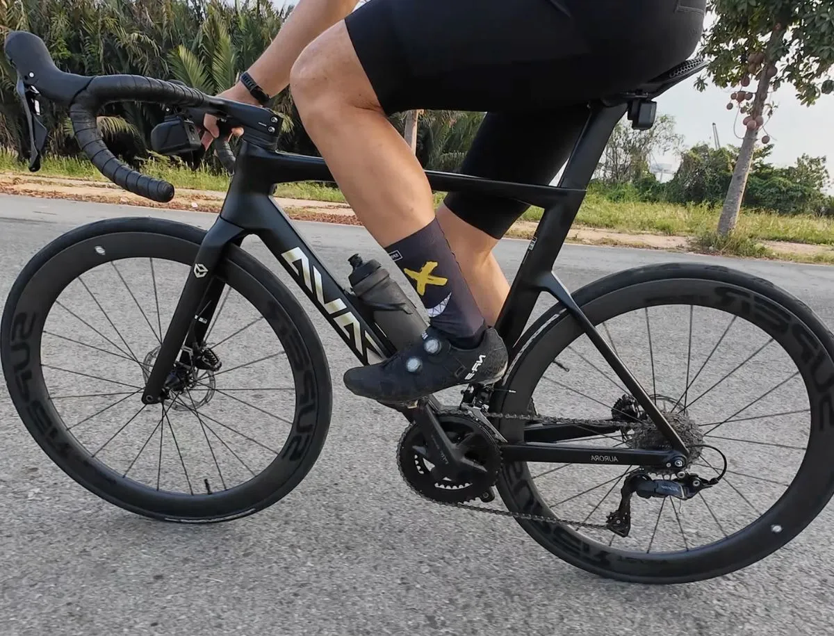 Cyclist riding a road bike fitted with Superteam Classic Pro carbon wheels during outdoor road testing