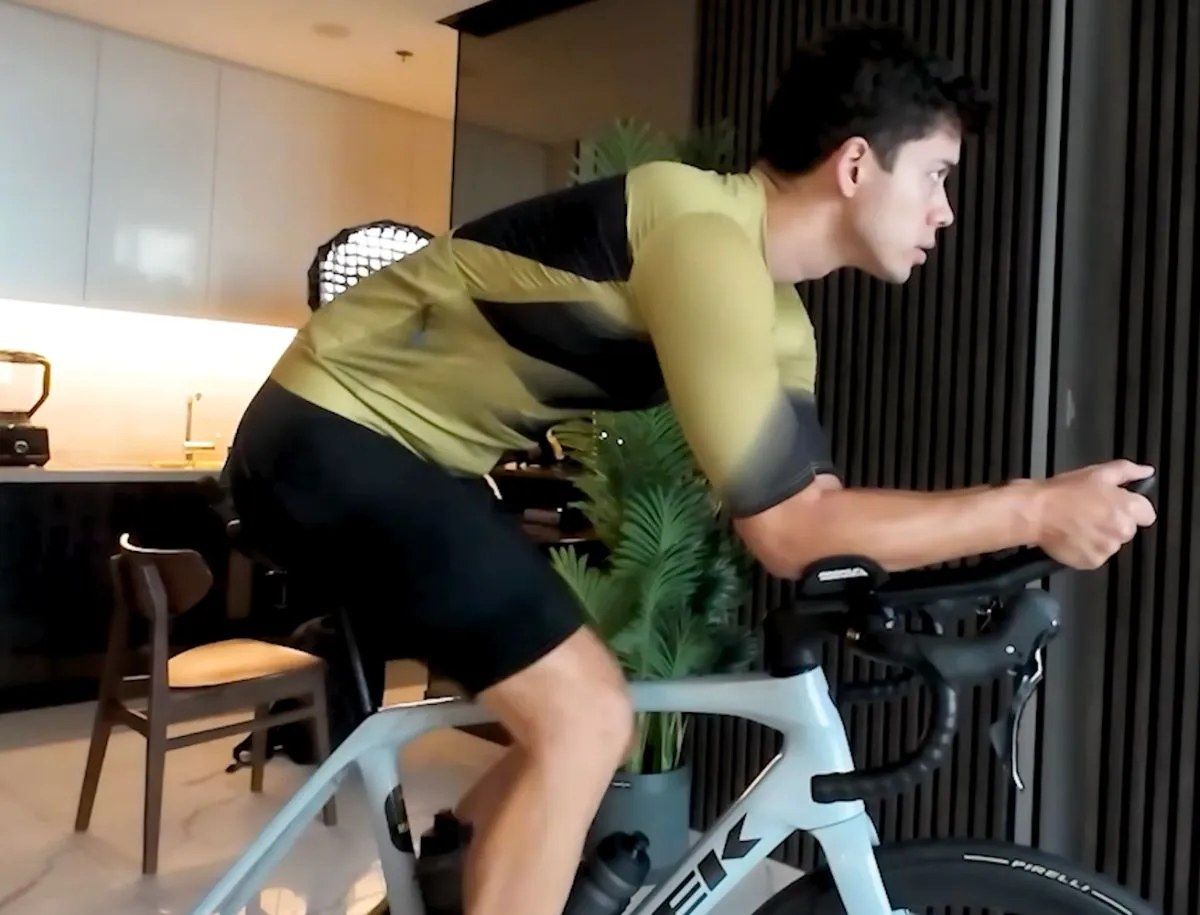 Mike Dee in aero riding position on a Trek road bike fitted with Pirelli tires, wearing YKYWBike AliExpress bib shorts during a fit test