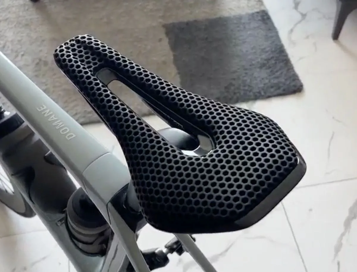 Ryet Black 3D-printed lattice cycling saddle mounted on a Trek Domane seatpost, viewed from above showing honeycomb foam structure and central cutout
