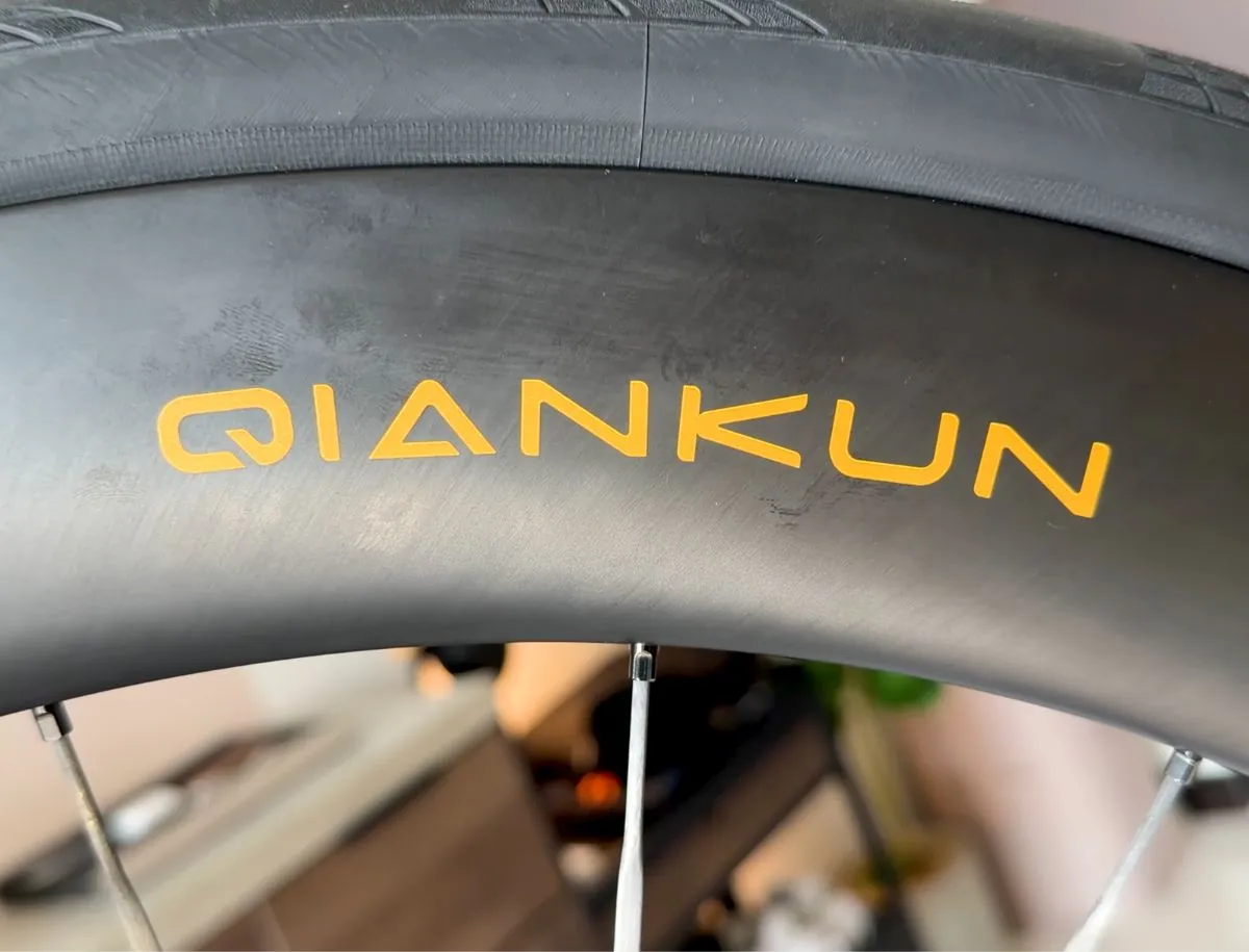 Close-up of matte black YOELEO QianKun CS60 T1000 carbon rim with gold QIANKUN decal