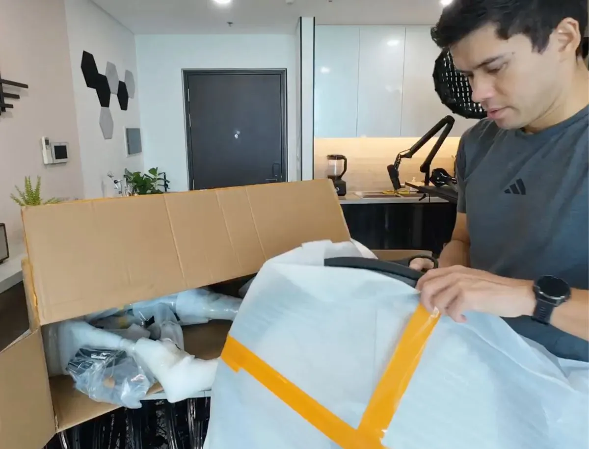 Mike Dee from BikeLabHQ unboxing the Seraph TT-X71, unwrapping the carbon frame and fork from protective packaging at home