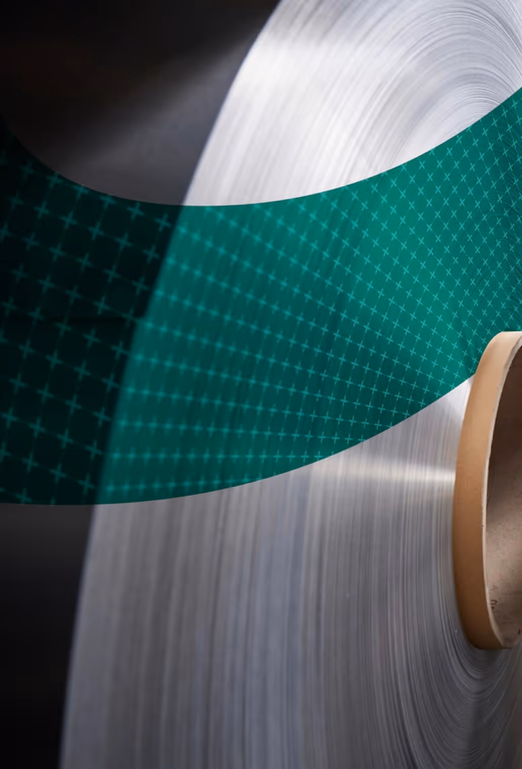 Close-up of a premium raw aluminium coil with a green patterned graphic overlay, representing Euramax architectural coating and manufacturing excellence.