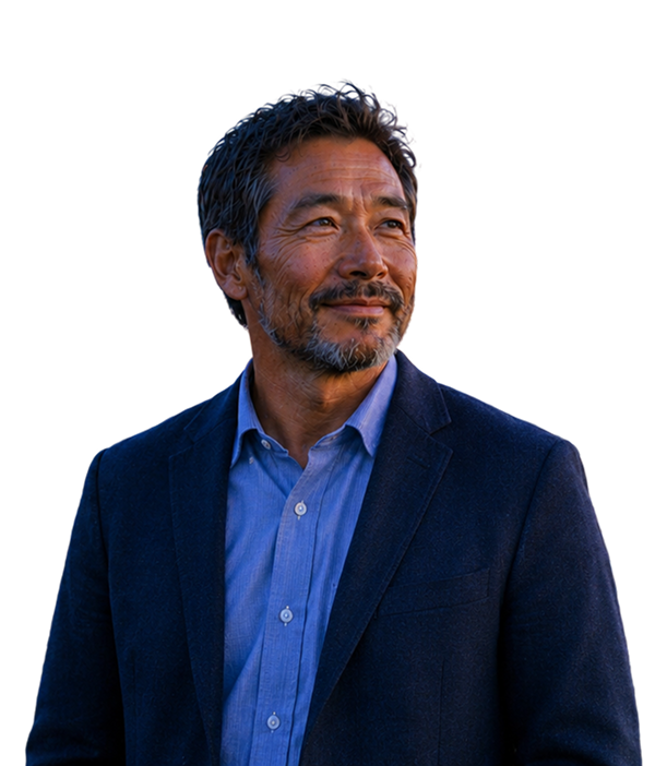 Smiling middle-aged man with a beard wearing a blue suit jacket and shirt, looking to the side.