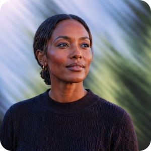 Portrait of a thoughtful woman wearing a dark sweater with blurred natural background.