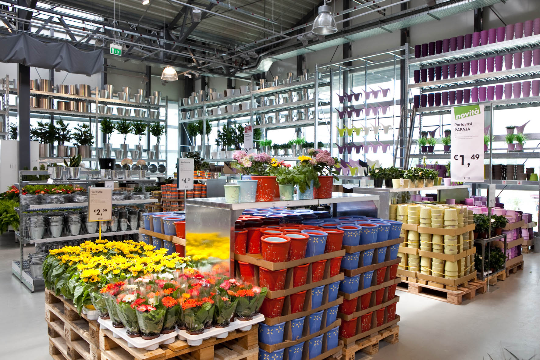 IKEA garden centre retail floor with seasonal flowers and stacked glazed plant pots