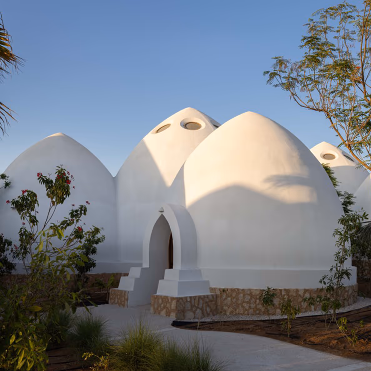 Domed architecture exterior with landscaping by Emkaan