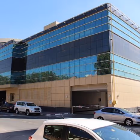 Modern glass office building exterior by Emkaan