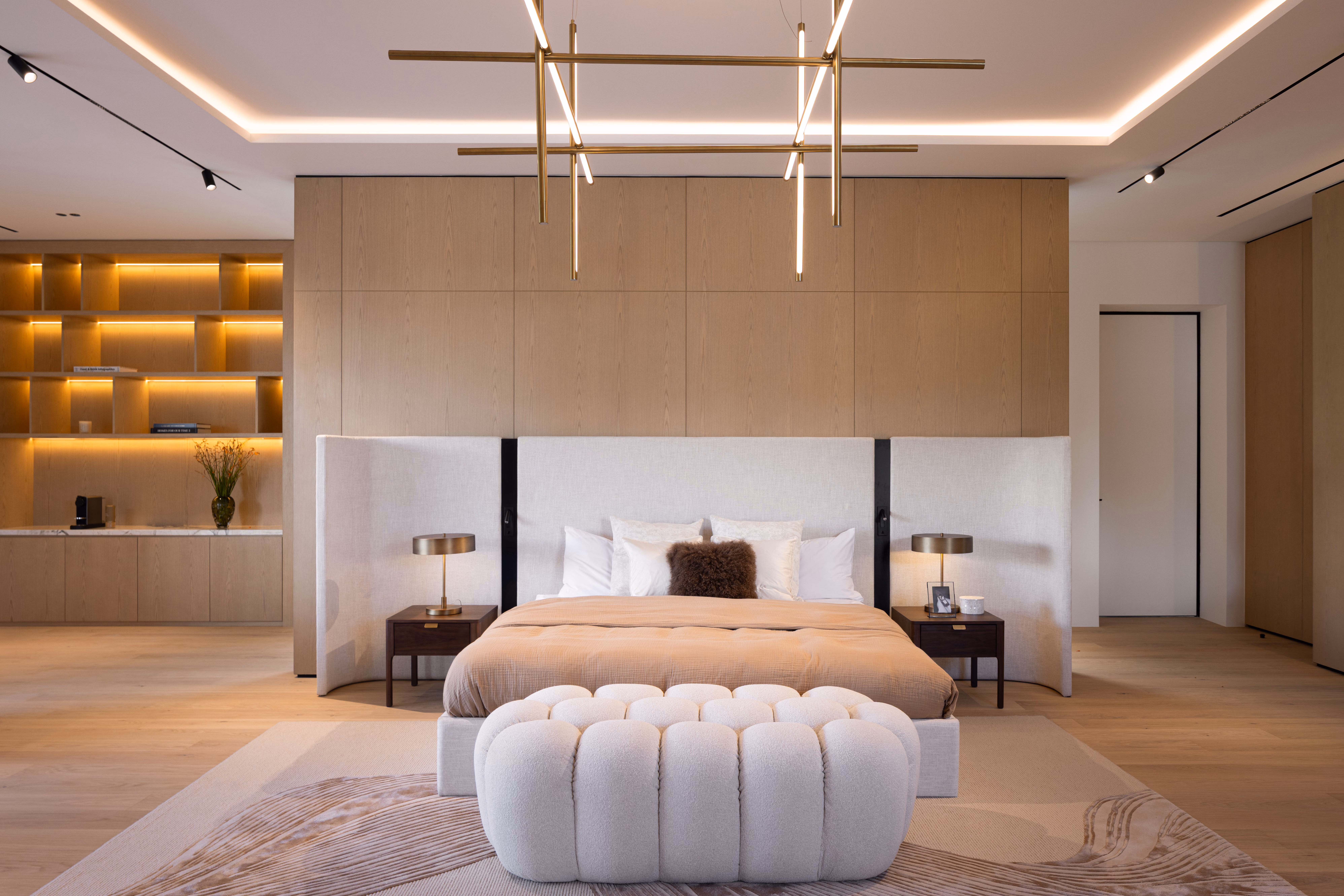 Luxury bedroom interior with sculptural bed and chandelier by Emkaan