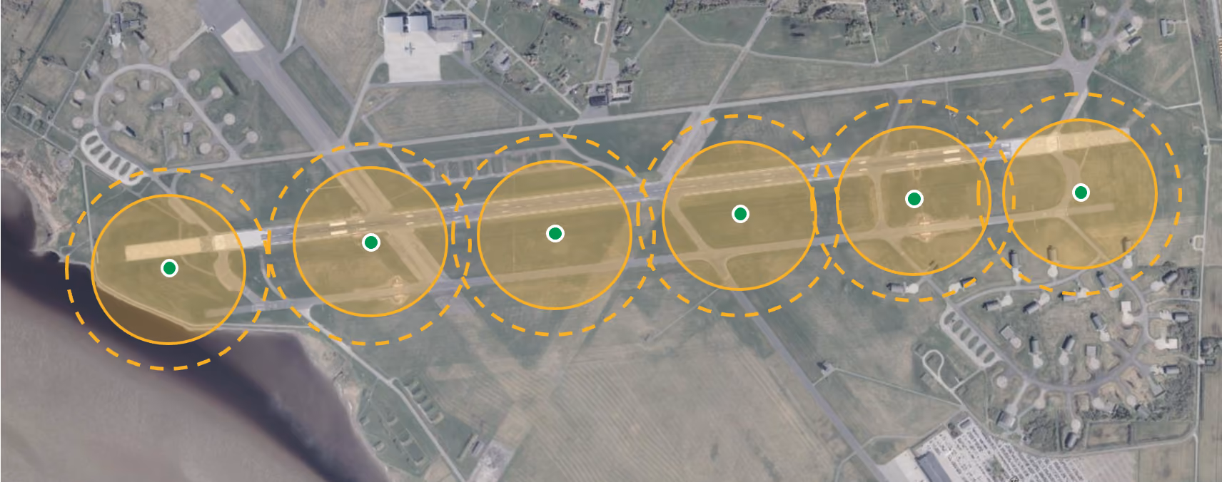Aerial view of an airfield with six overlapping yellow circles marking runway zones.