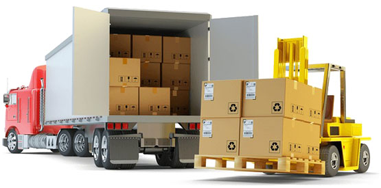 Yellow forklift loading cardboard boxes onto a red semi-truck with an open trailer.