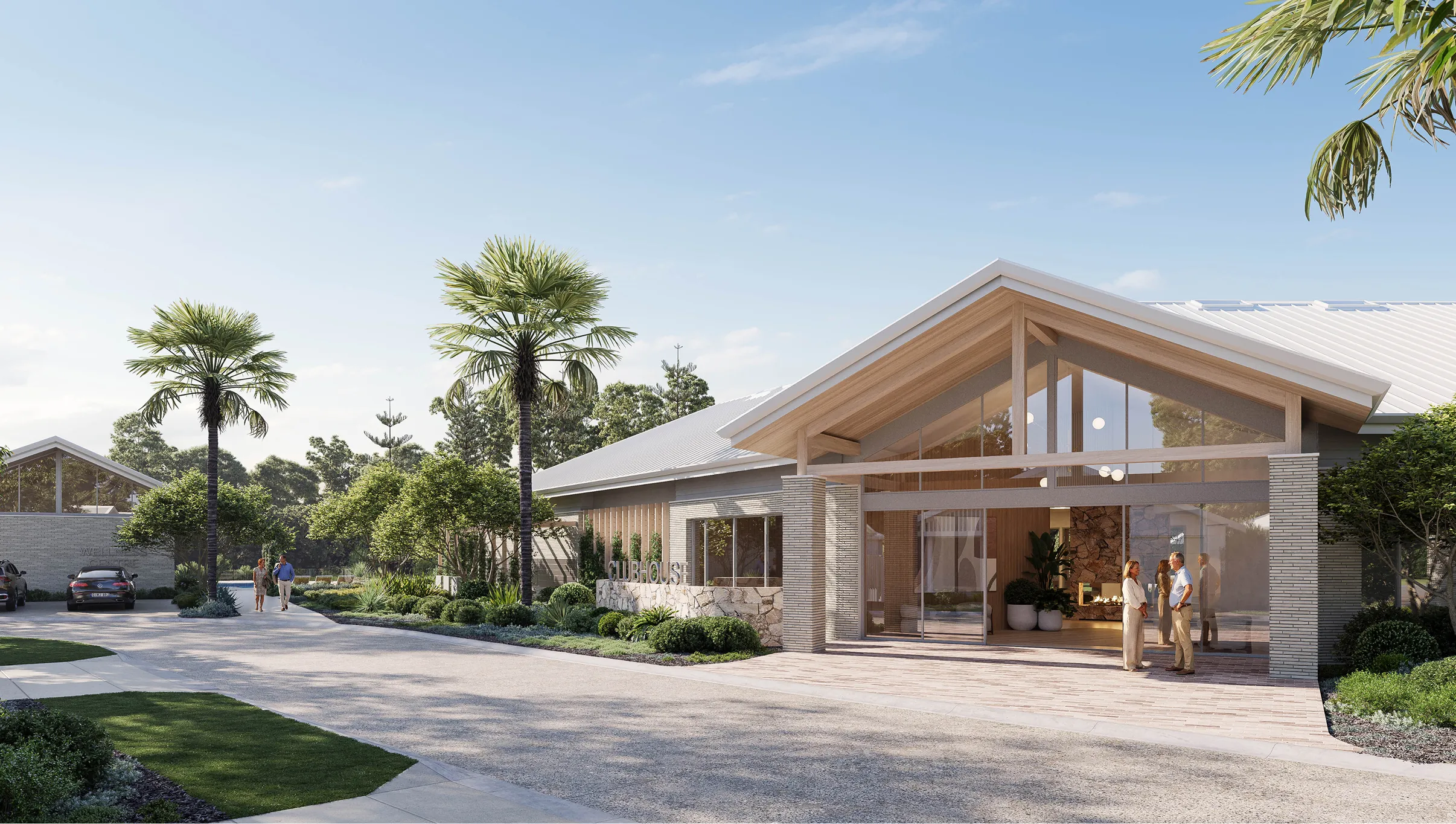 Modern clubhouse with glass entrance, palm trees, landscaped garden, and people talking outside on a sunny day.