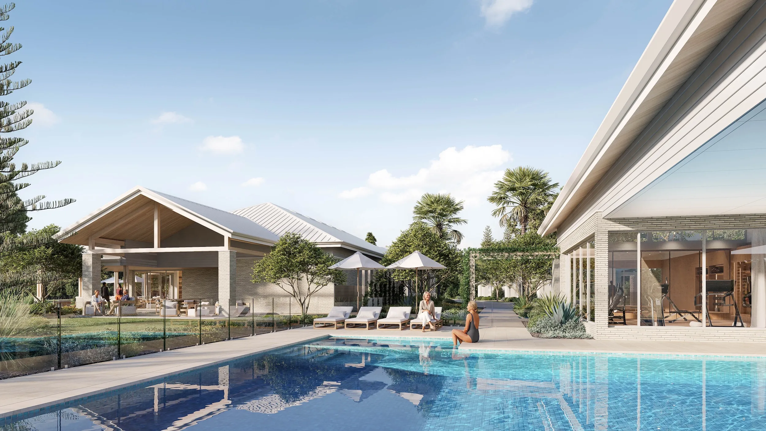 Modern outdoor pool area with lounge chairs, umbrellas, and people relaxing near a house with large windows.
