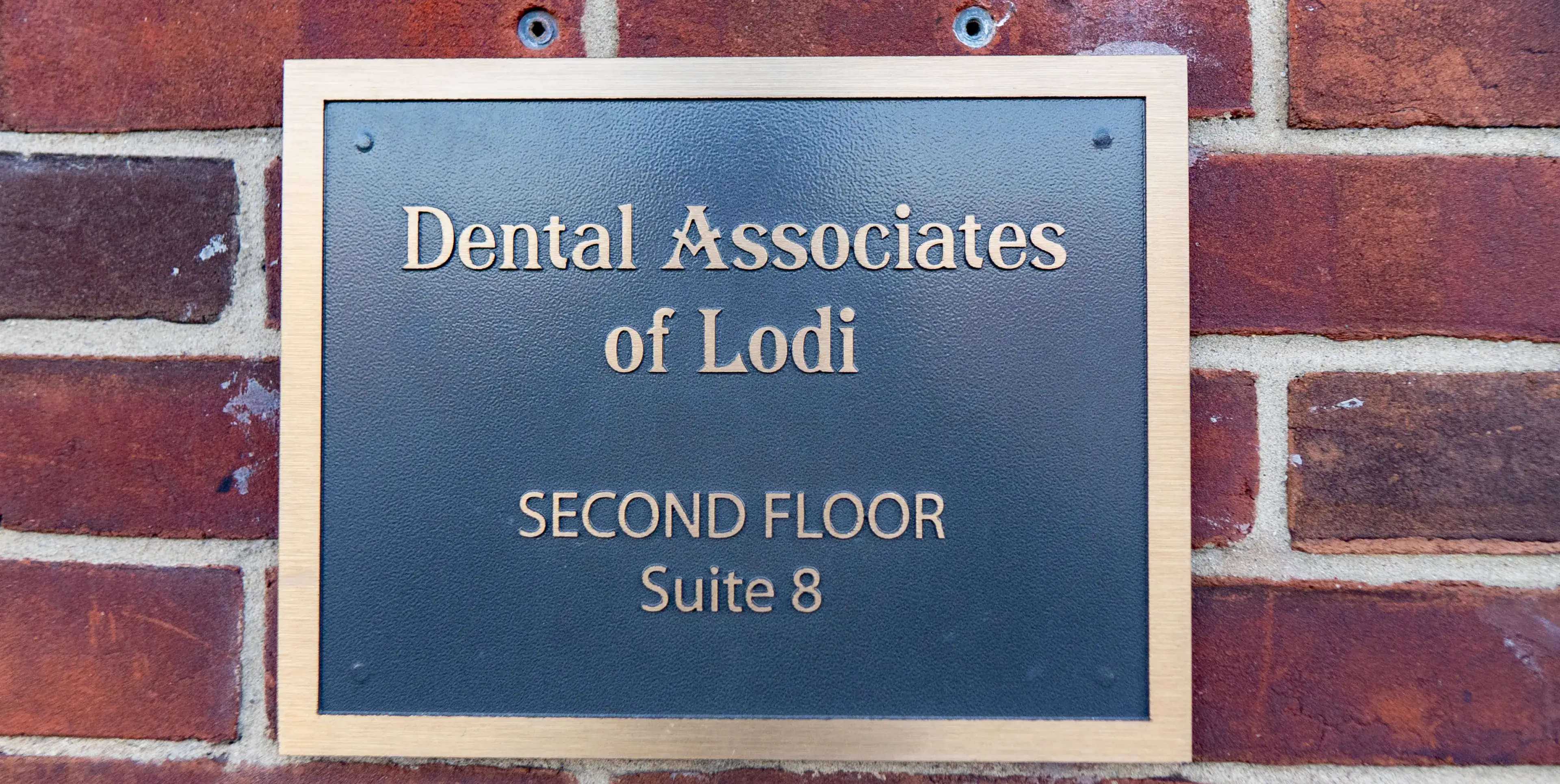 Sign for Dental Associates of Lodi, located on the second floor, suite 8.