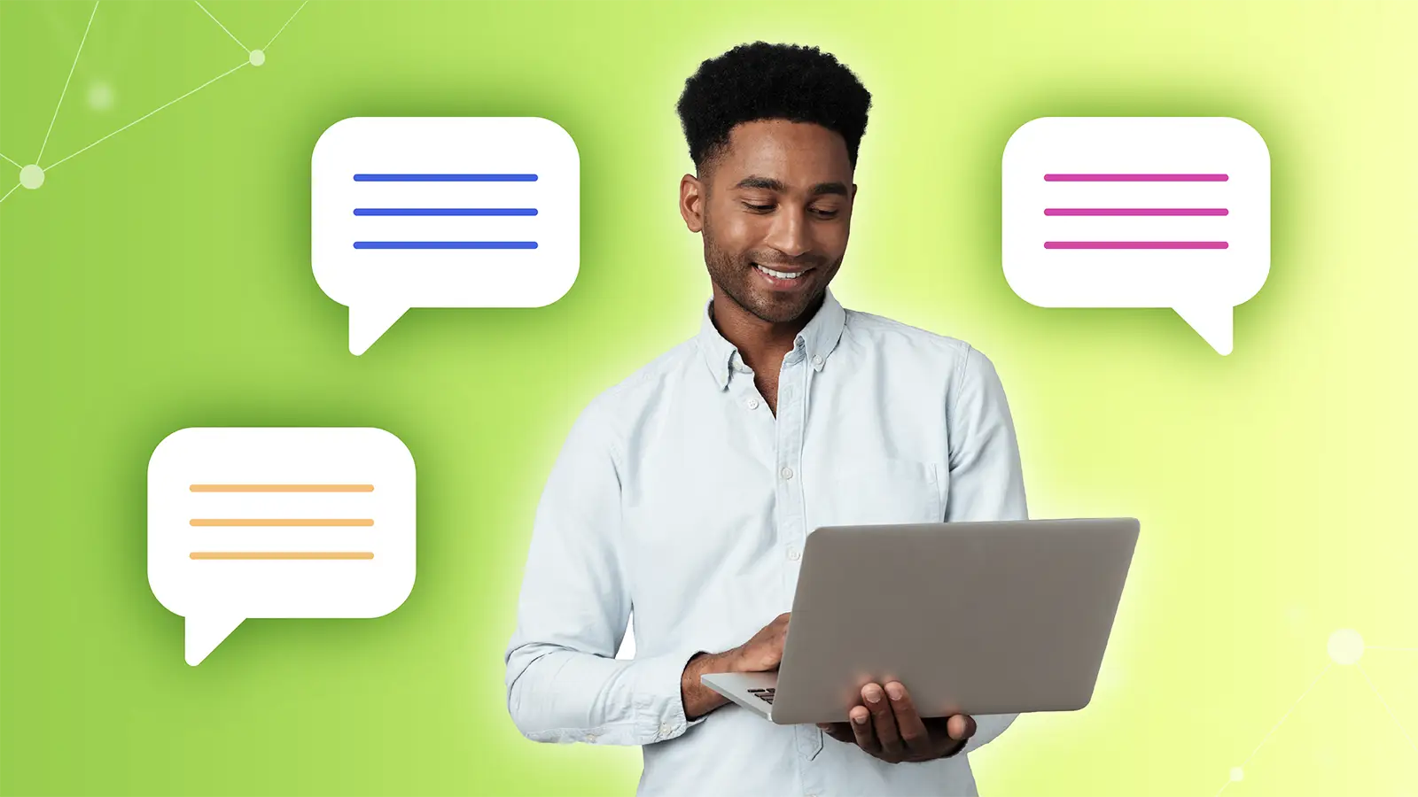 Smiling man holding a laptop with colorful chat bubbles around him on a green background.