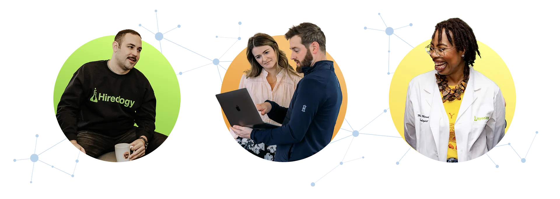 Man in Hiredogy sweatshirt holding a cup, two people looking at a laptop, and woman smiling in a white coat.