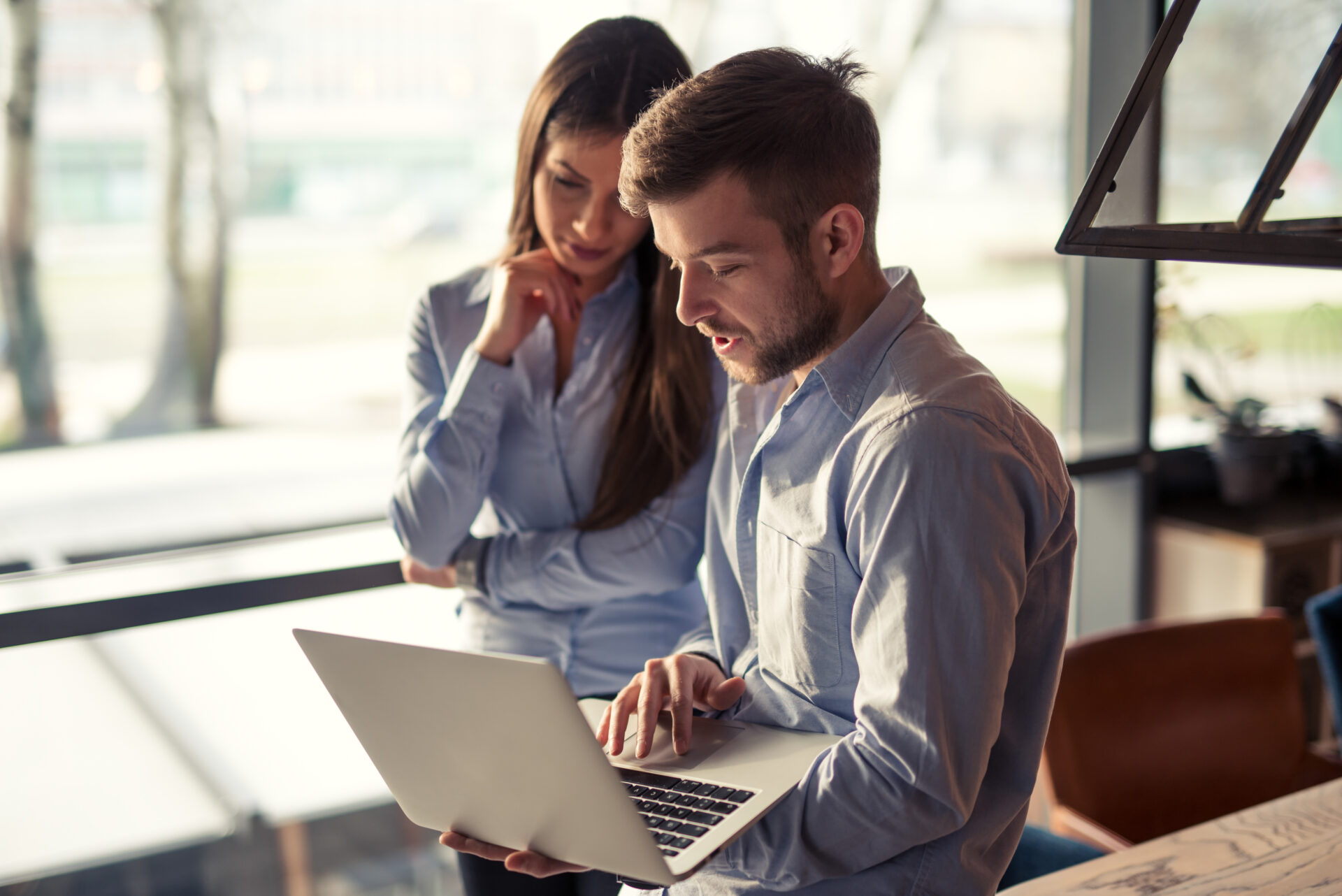 Hiring team reviewing candidates together at a laptop