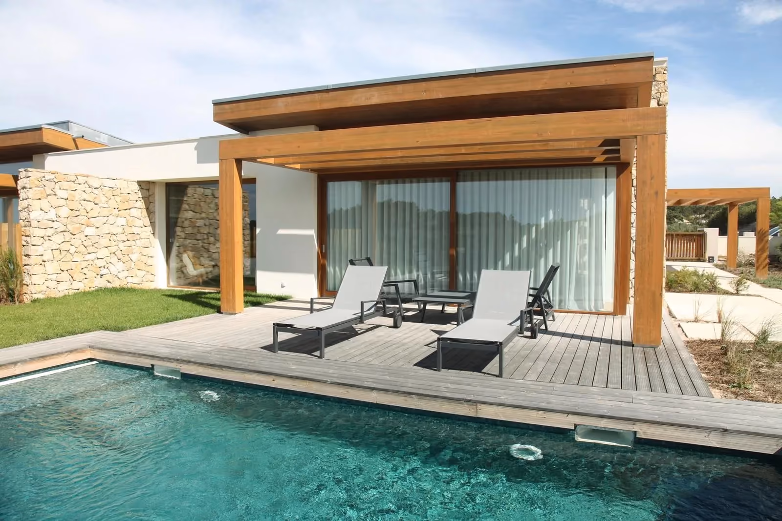 Newly built modern Mediterranean home with large glazing and a pool
