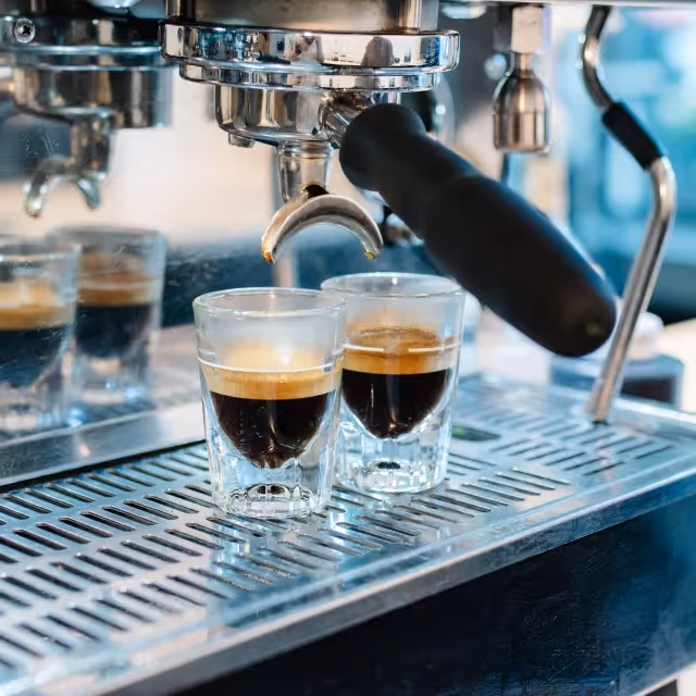 A coffee machine pouring two shots of espresso.