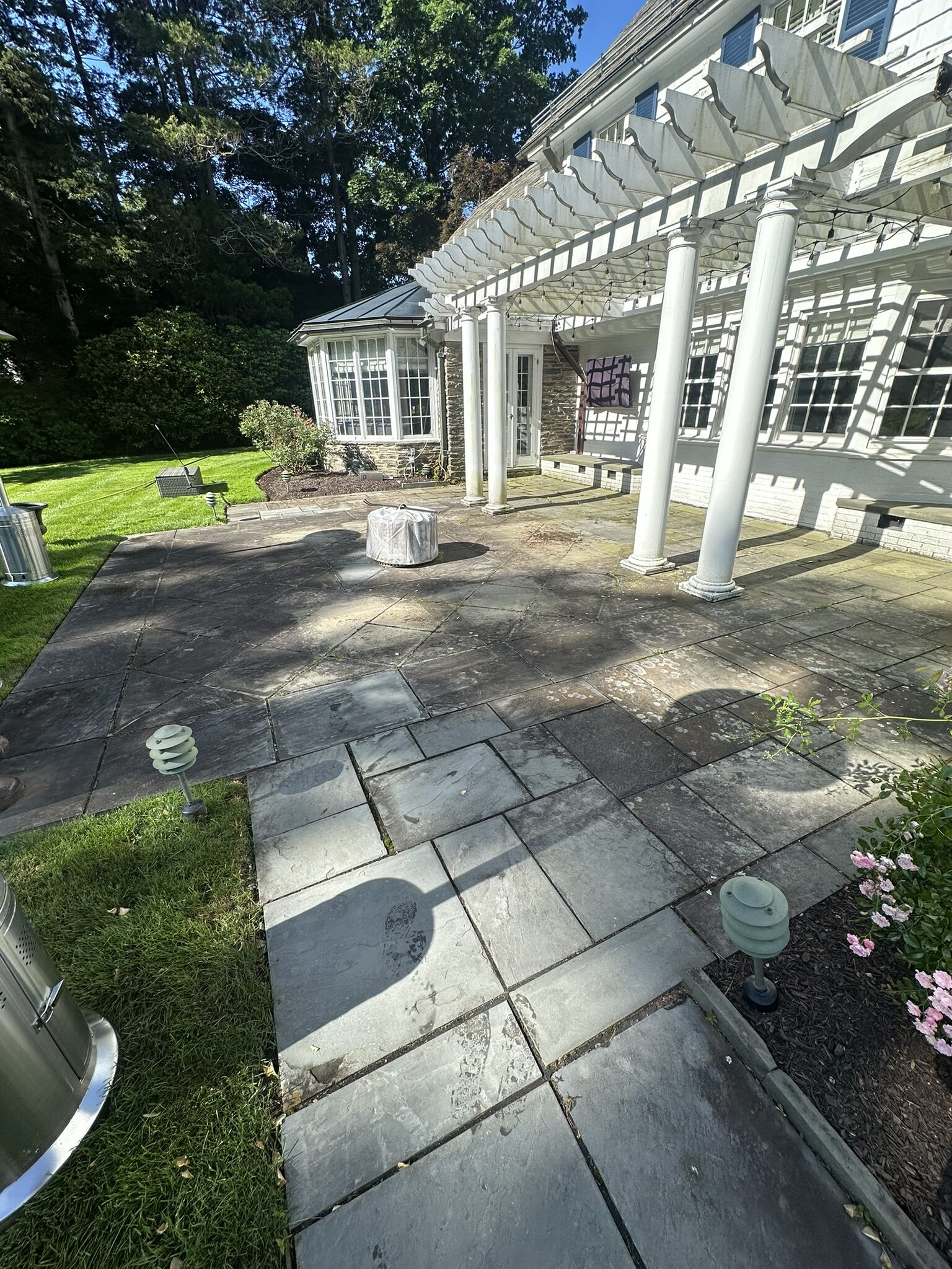 Clean bluestone patio with a pergola in Tolland County, CT