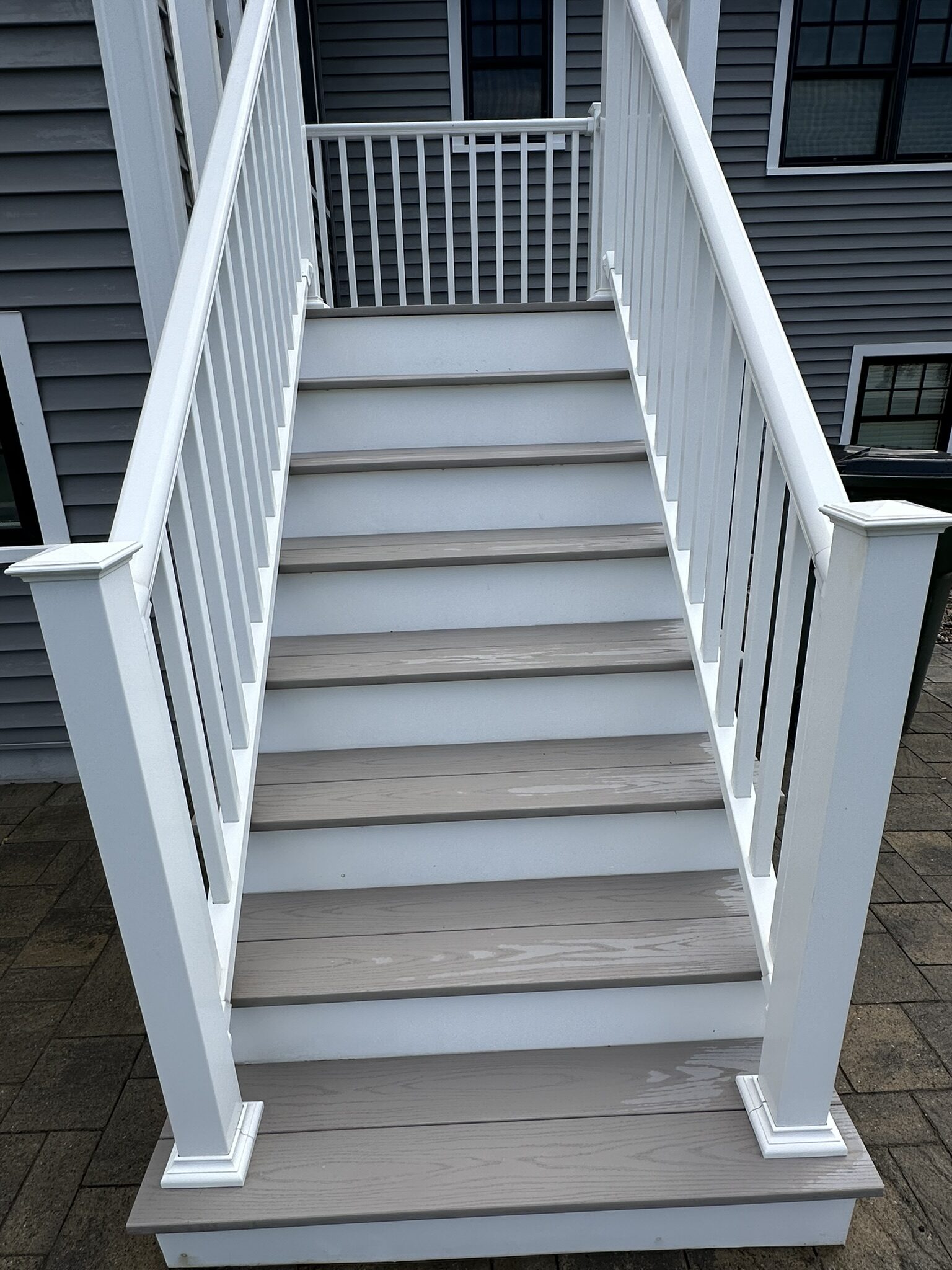 Clean composite deck stairs after low-pressure washing