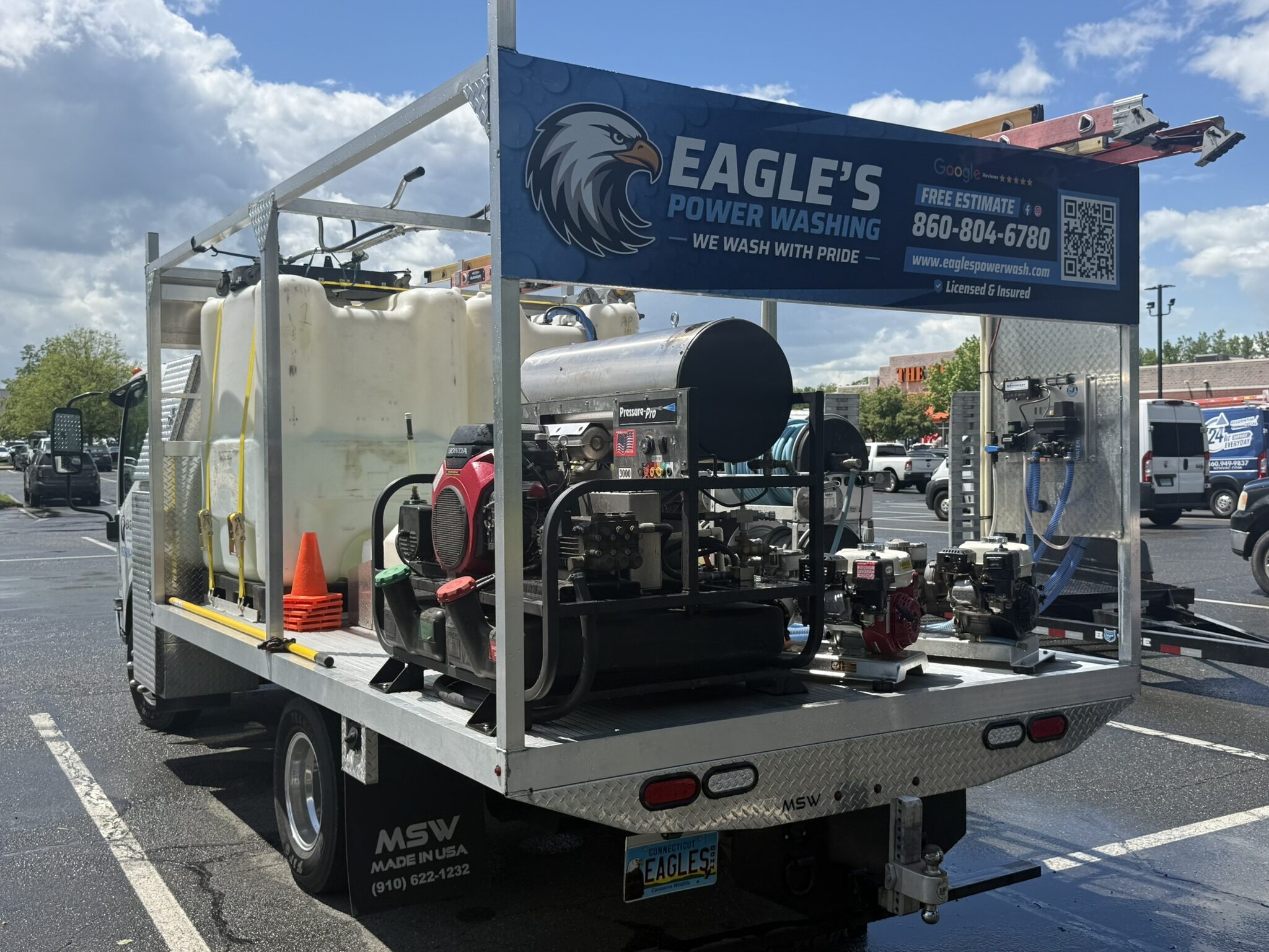 Eagle's Power Washing truck rig with tanks, hoses, and pressure washing equipment