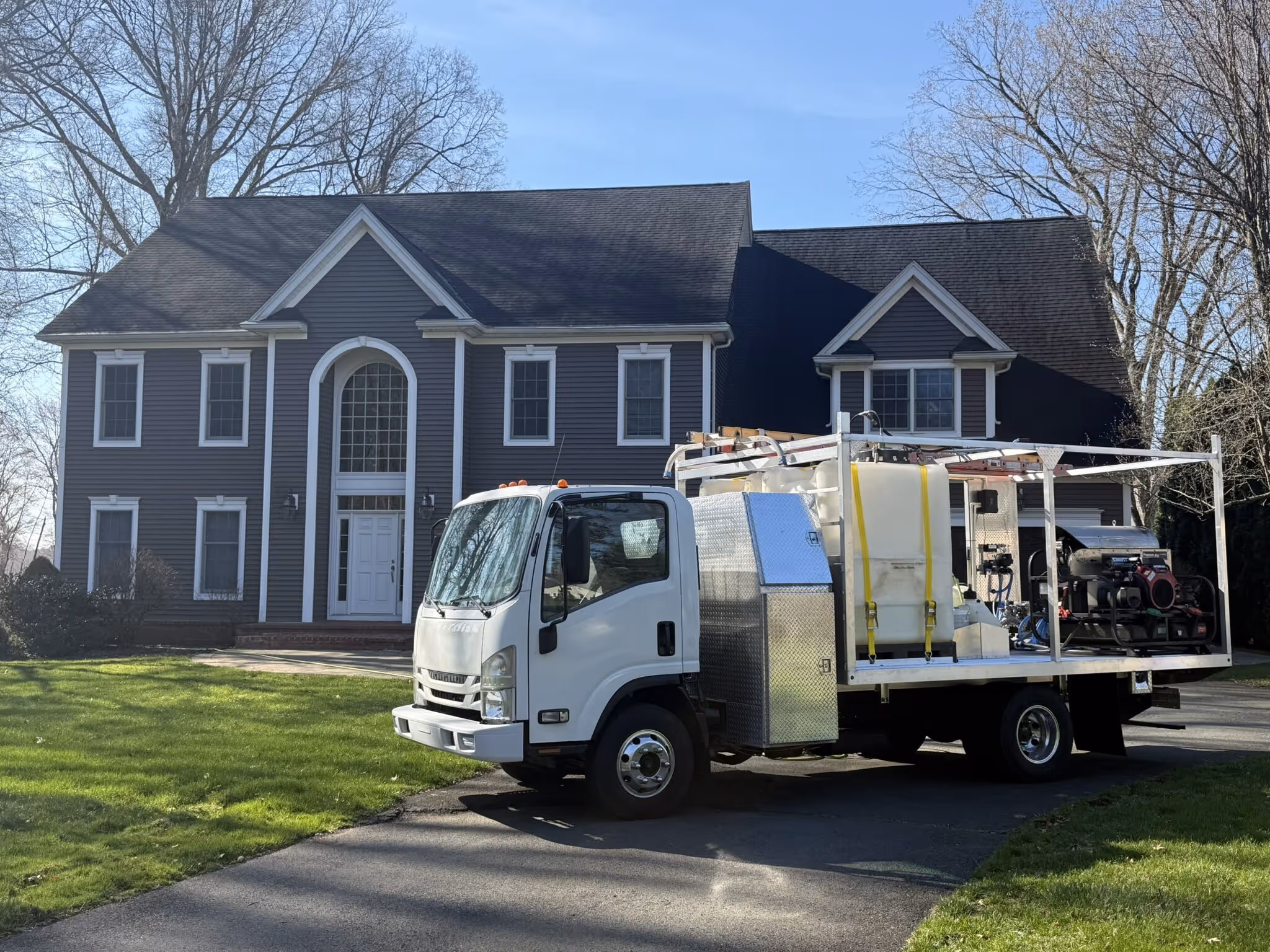 The Eagle's Power Washing truck at a Greater Hartford home, with the owner on every job
