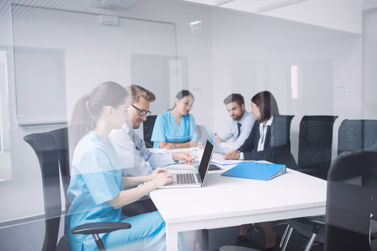 Doctors discussing laptop meeting