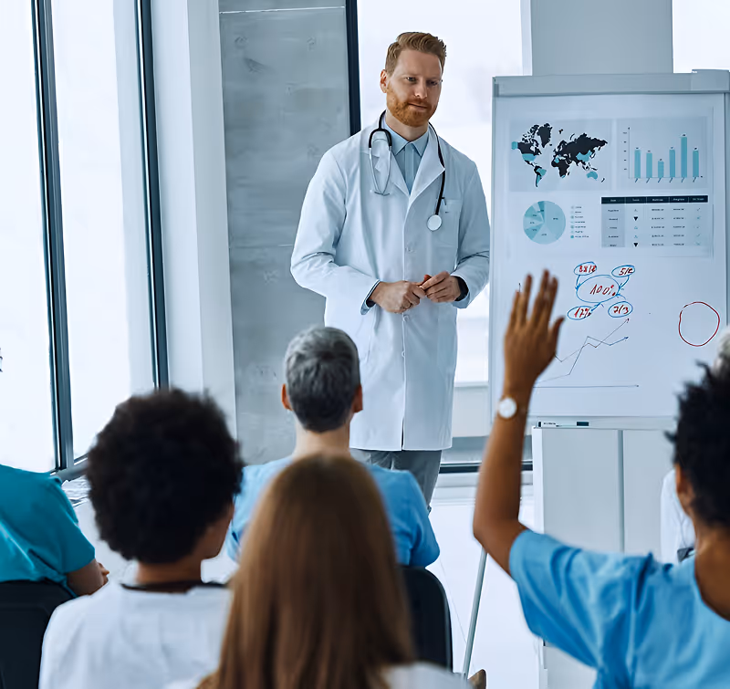 Male doctor with stethoscope giving a presentation