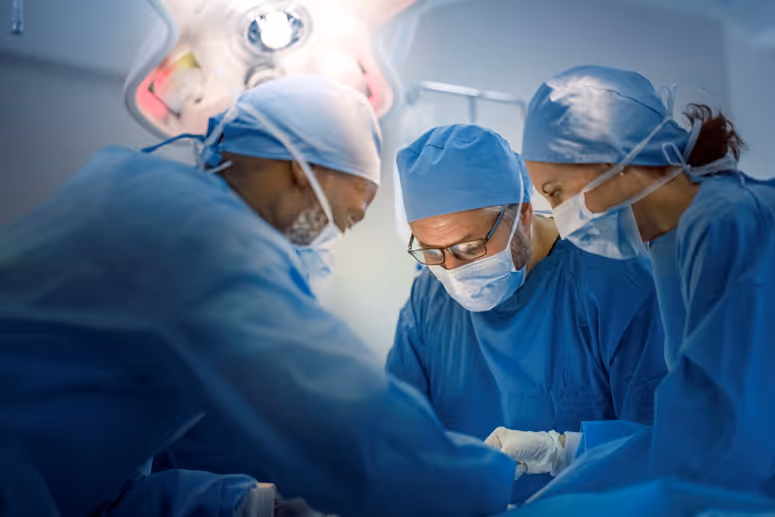 Surgeons collaborating in an operating room representing value-based enterprise partnerships for TEAM