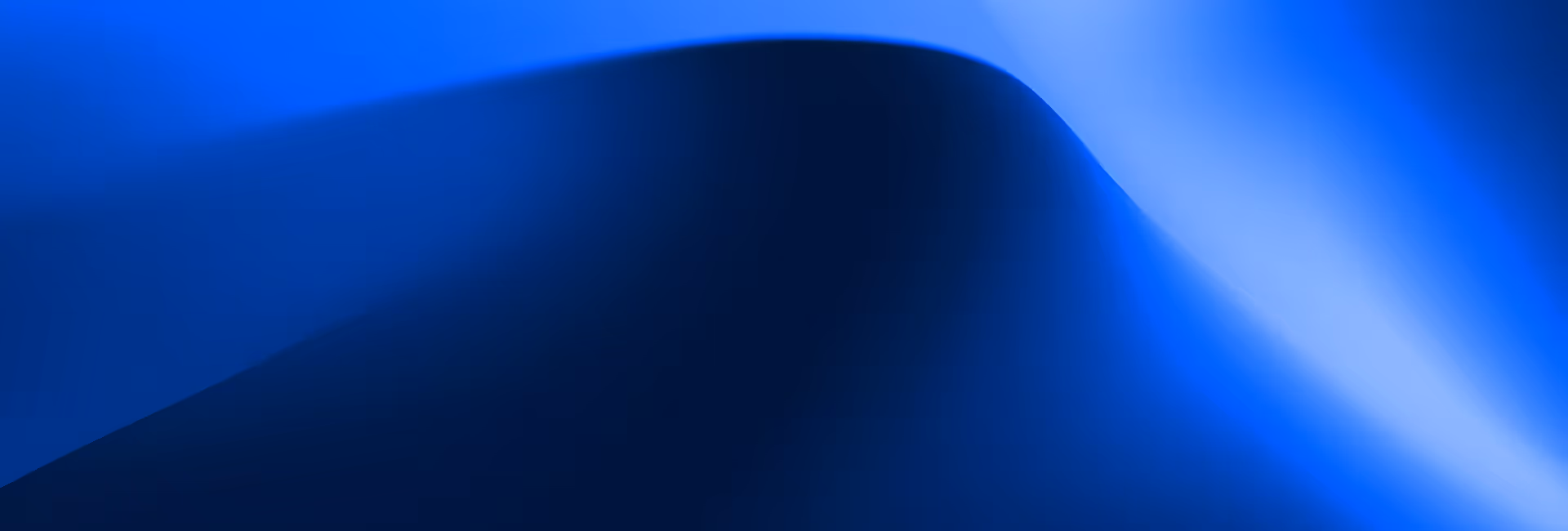 Abstract smooth blue gradient with light and dark curving shapes.