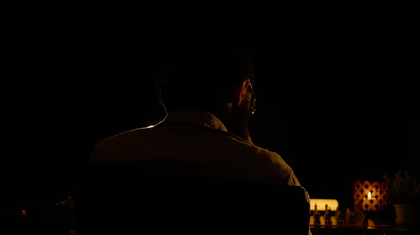 Man sitting at a desk in contemplation, strategizing and planning.