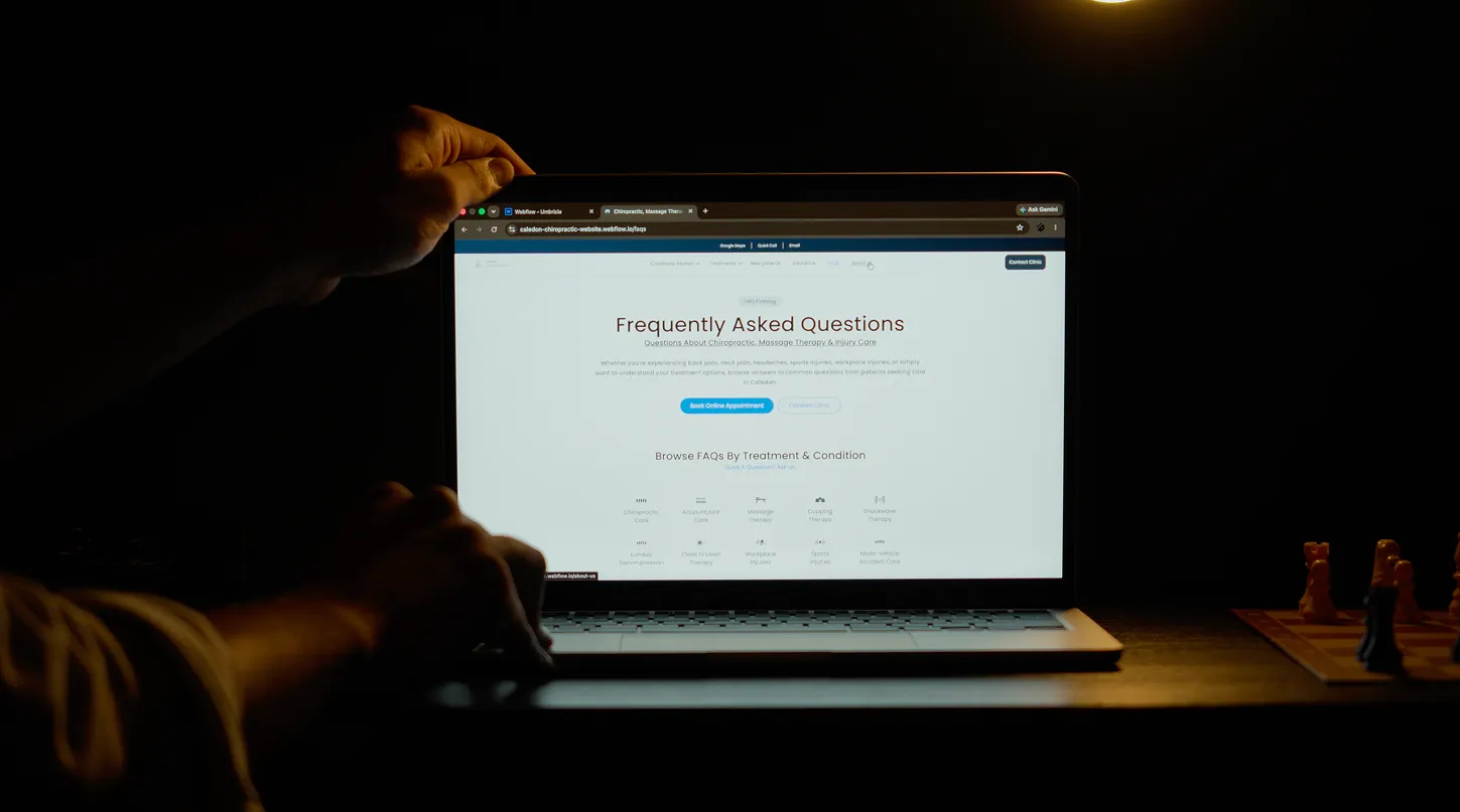 Man demonstrating a completed website user interface and layout on his laptop.
