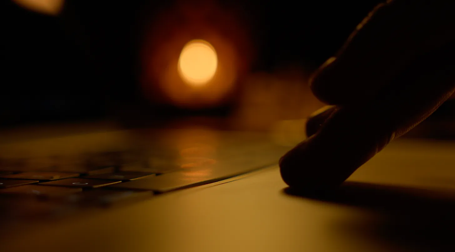 Man utilizing a laptop trackpad to browse.