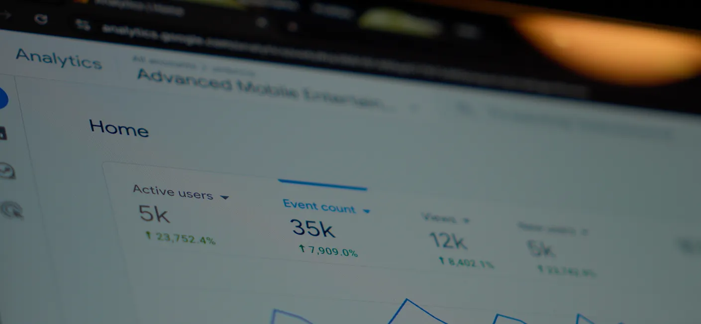 Google Analytics showing positive website statistics on a laptop.