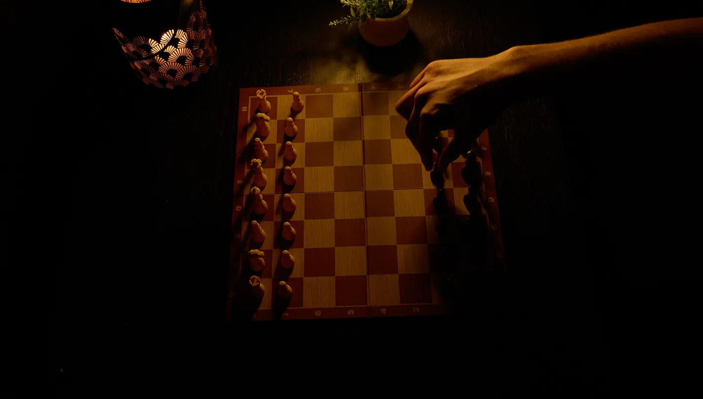Man making the first move in a chess game.