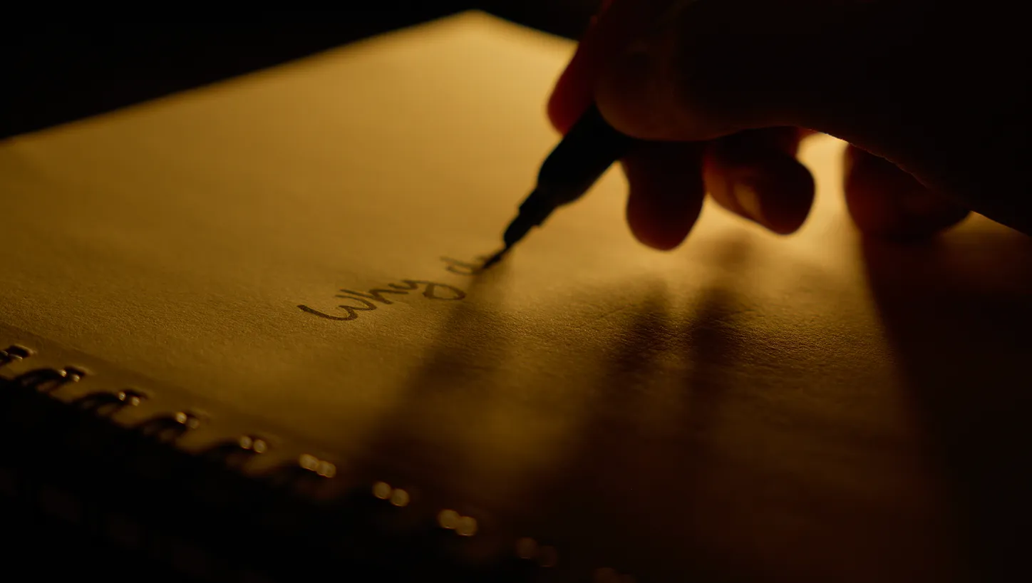 Man writing on a notebook.