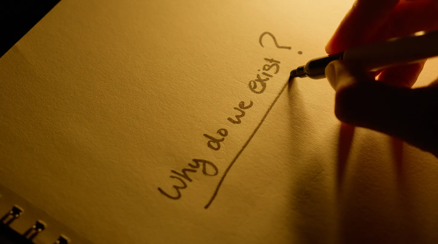 Man underlining a question in his notebook asking "why do we exist?"