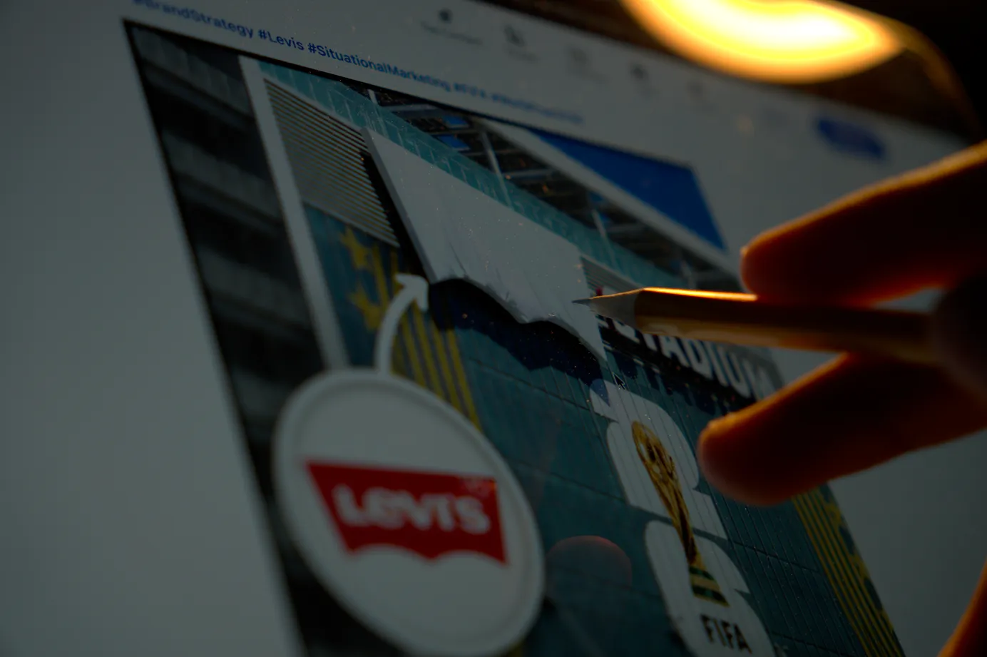 Man studying a Levi's marketing and branding case study on his laptop.