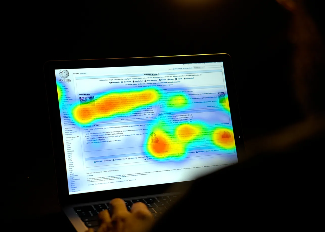 Man studying an example of a bad website through a heatmap.