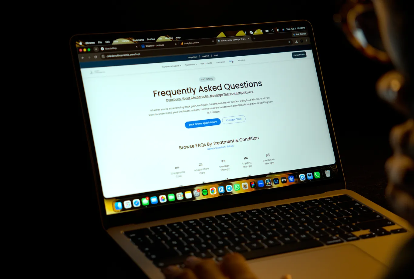 Man looking at a Frequently Asked Questions page on his laptop.