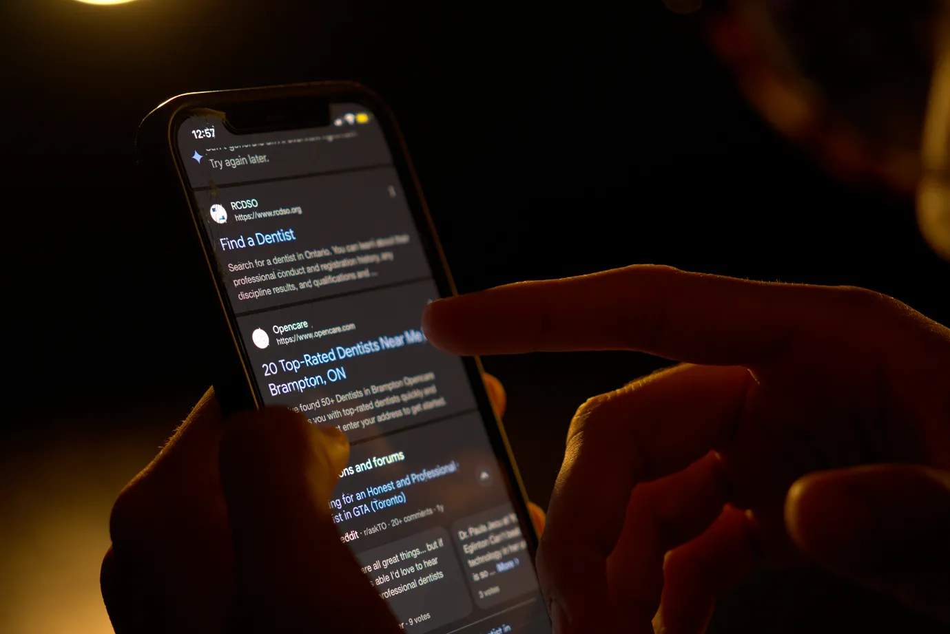 Man assessing a list of landing pages on his phone following a google search inquiry.