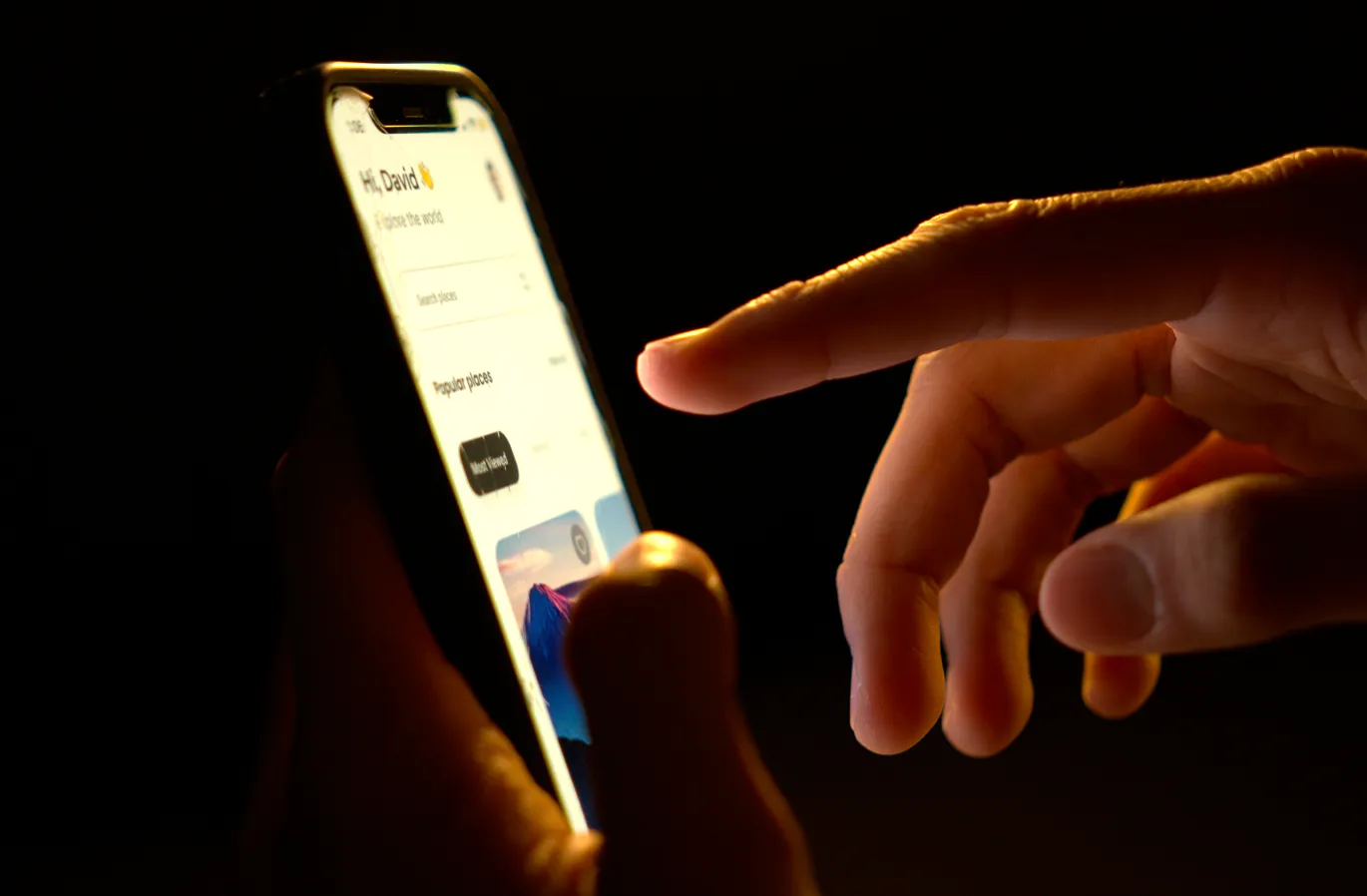 Man testing a website's mobile user interface on his phone.