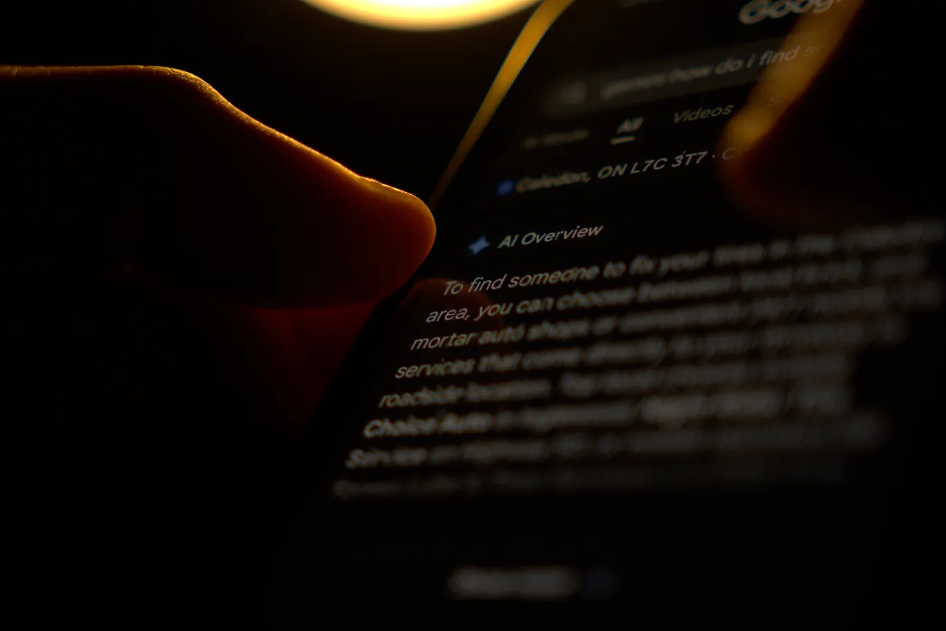 Man reading google's AI overview on his phone following an inquiry.